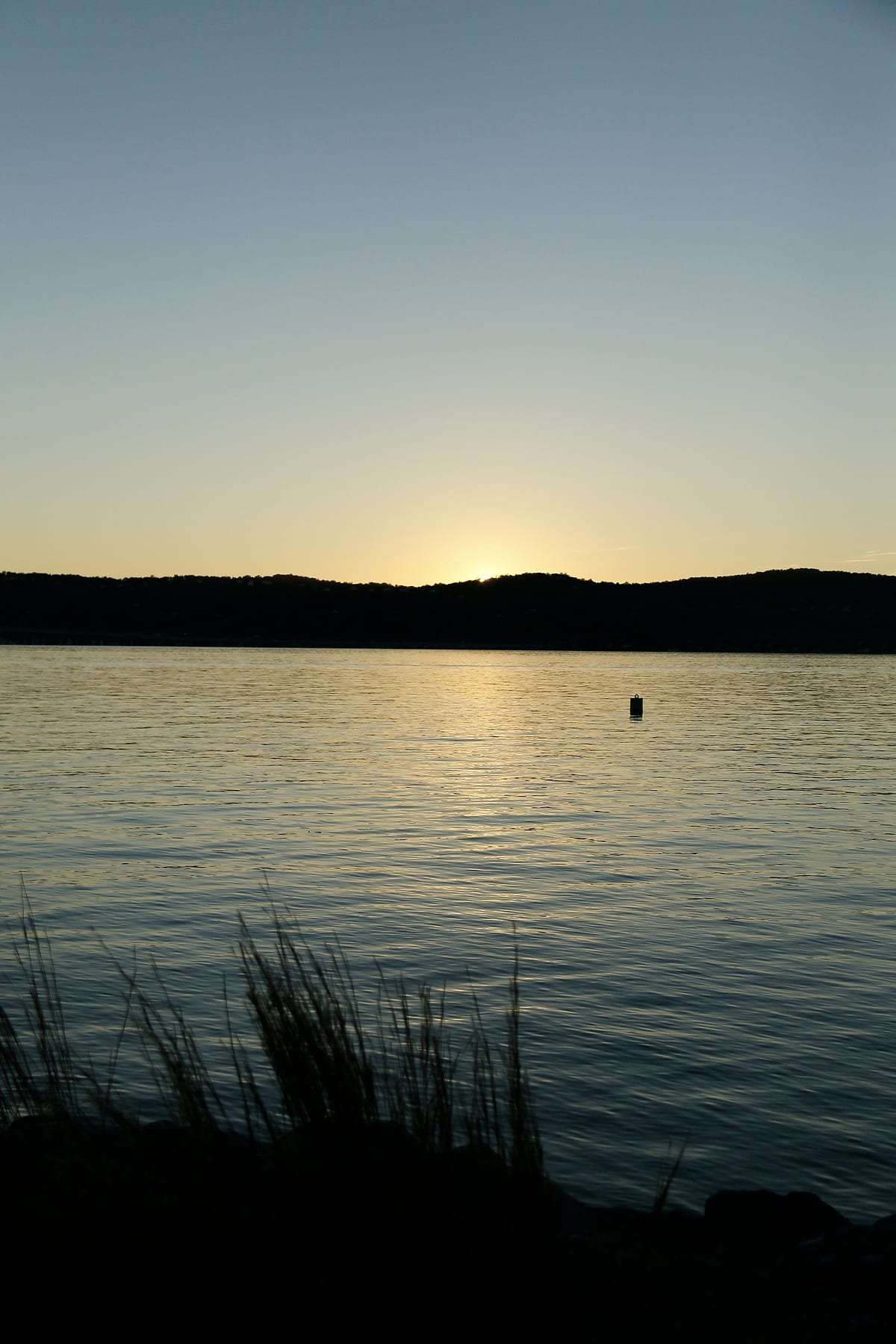 The river just after the sun has gone behind the hills.